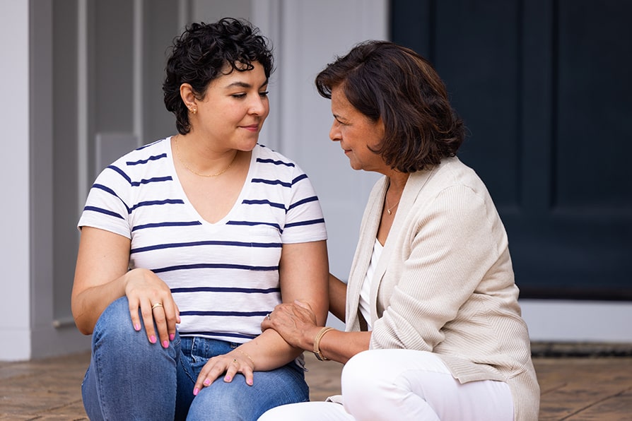 Laura comforting Layra, a YESCARTA® (axicabtagene ciloleucel) patient ambassador.