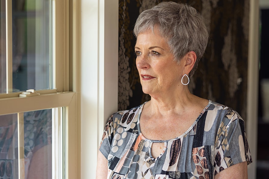 Margaret YESCARTA® (axicabtagene ciloleucel) patient ambassador looking out the window.