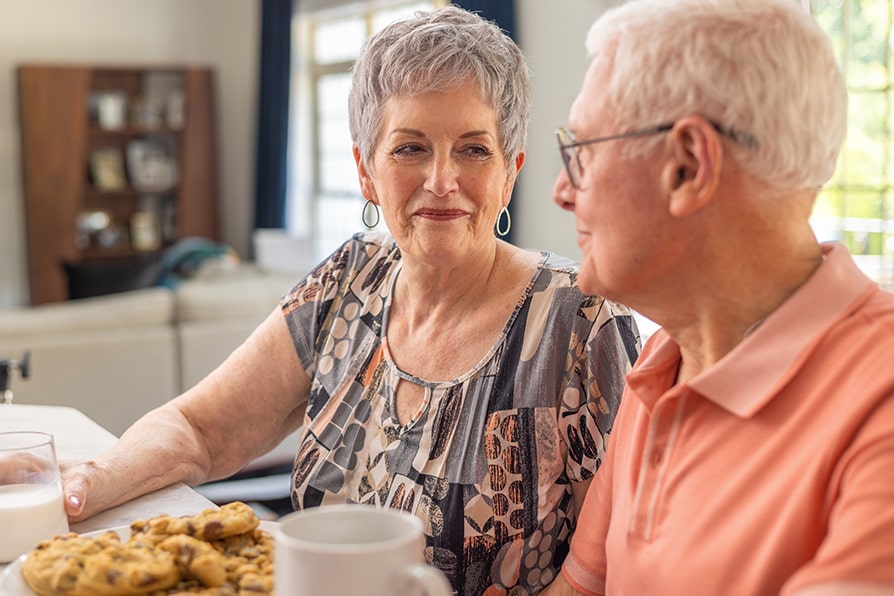 Margaret YESCARTA® (axicabtagene ciloleucel) patient ambassador sitting with caregiver Skip.